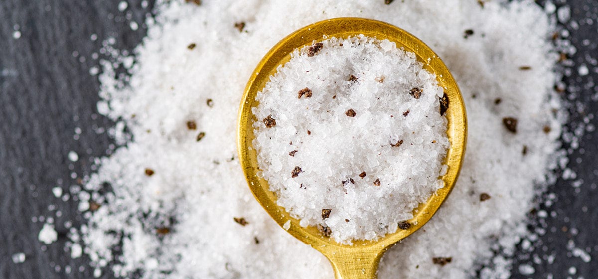 Italian Black Truffle Sea Salt in a gold spoon up close macro 