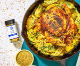Image of a jar of Summit Country salt free seasoning next to a whole roast skillet chicken with fennel and potatoes. 